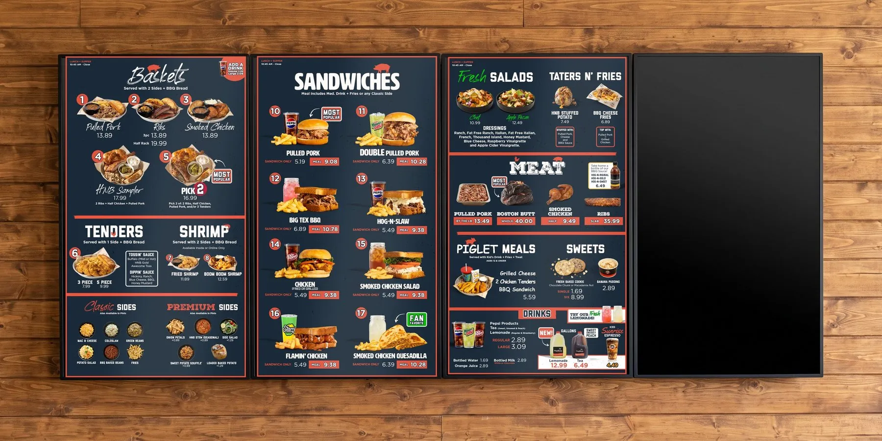 Four vertical digital menu panels on a wood plank wall showing the Hog-N-Bones lunch and supper menu system, with a rolling promo screen